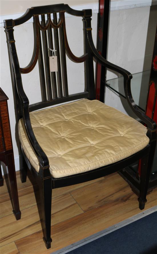 A pair of ebonised elbow chairs